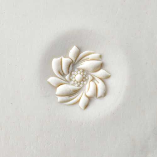 curve top whirling flower pottery stamp